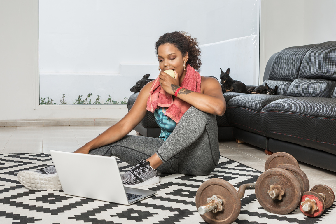 Sportswoman Eating Apple After Workout 